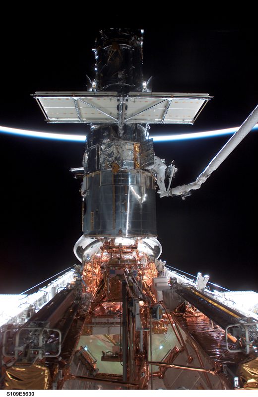Astronaut Michael Massimino conducts repairs on the Hubble telescope from Space Shuttle Columbia